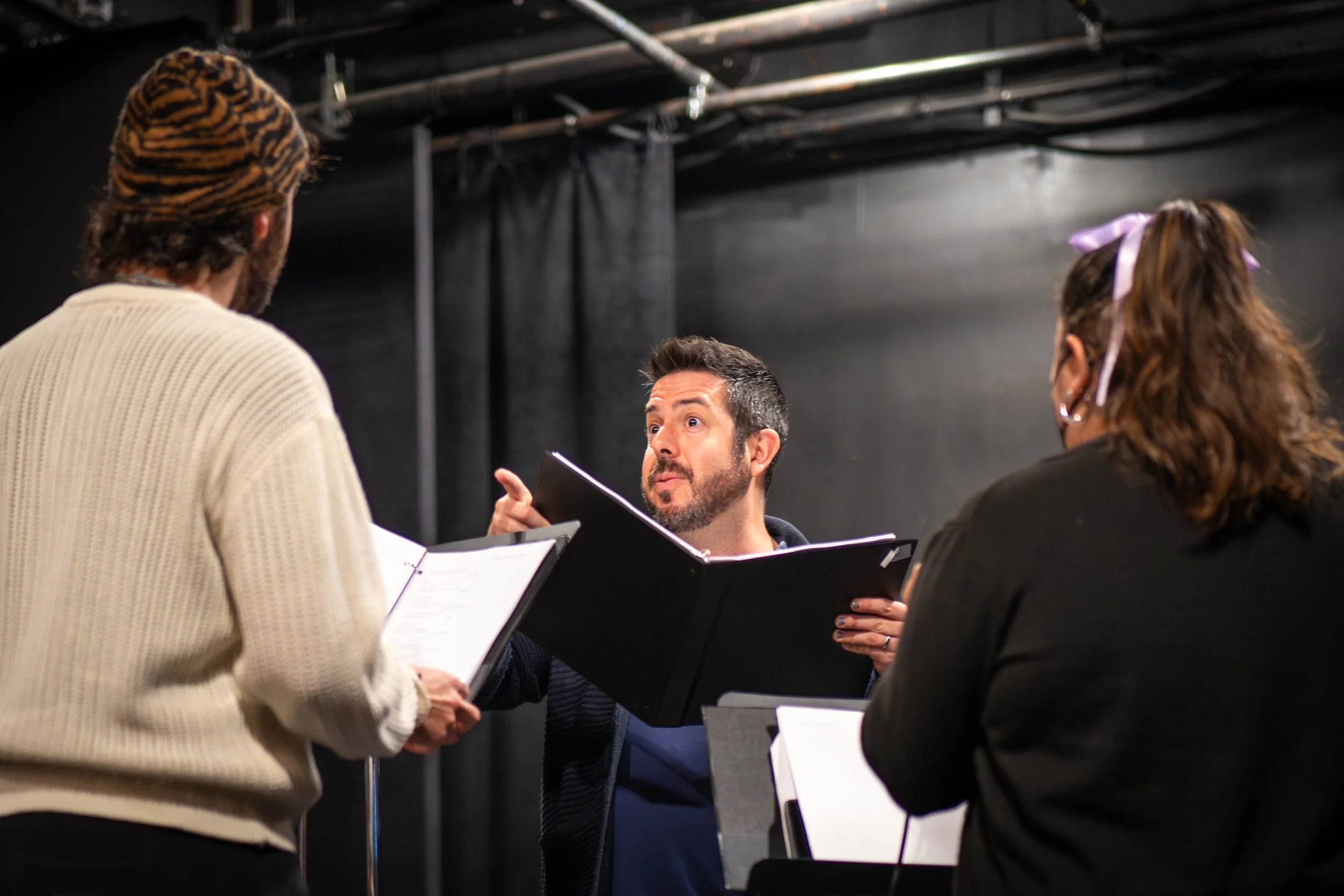 Jay Ilan working with cast in rehearsal
